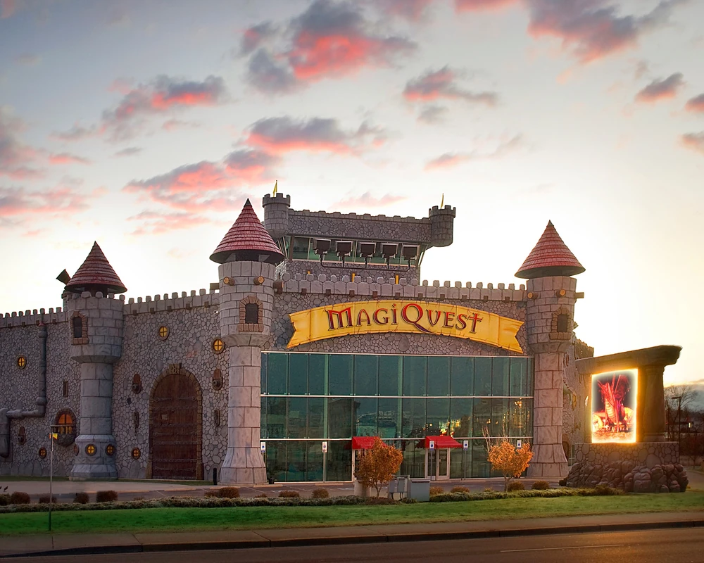 A picture of the Pigeon Forge MagiQuest building from the outside. You can see the sun setting in the background.